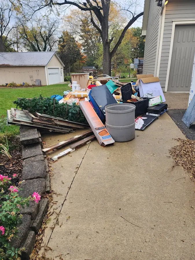 Dumpster being loaded with debris for Estate Cleanout Dumpster Rental in Stevensville